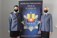 policjantki w umundurowaniu galowym stoją przy roll-upie.