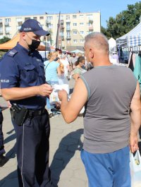 policjanci rozdają maseczki.