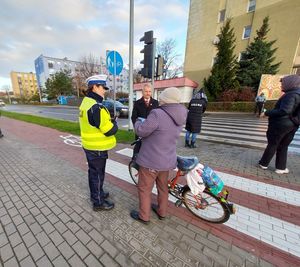 policjanci wspólnie z burmistrzem rozdają odblaski i zapachy samochodowe.